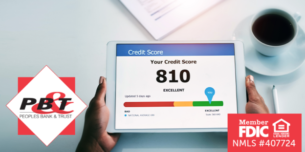 Person holding tablet displaying a credit score of 810 on the screen